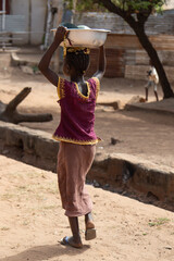 Poor negro village in Africa.Little African girl in a village.