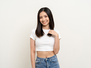 Fototapeta premium Beautiful smiling happy young asian woman age around 25 in white shirt. Charming female lady standing pose on isolated white background. Asian cute people looking camera confident with backdrop.