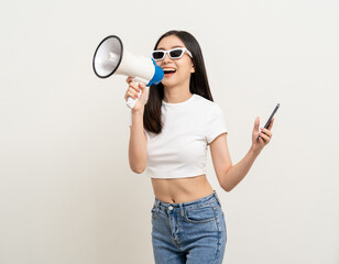 Shout out loud with megaphone. Young beautiful asian woman  announces with a voice about promotions and advertisements for products at a discounted price. Standing on isolated white background.