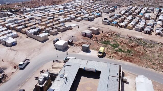 Drone shot of hundreds of tents inhabited by Syrian refugees for years due to the war that destroyed their homes.