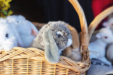 Plush bunnies in wicker basket.Easter decoration.