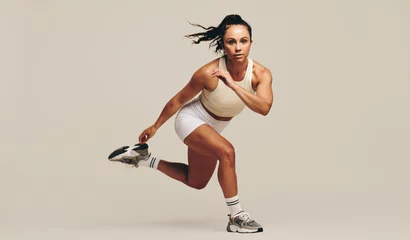 Papier Peint photo Lavable Fitness Intense workout session in a studio: Sportswoman doing strength training exercises
