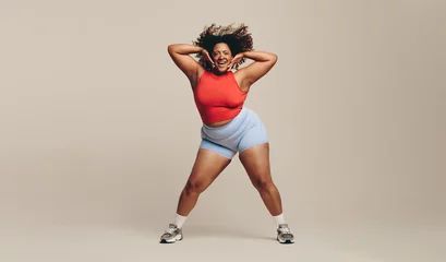  Fun and body movement: Fit woman enjoying a dance workout in a studio © Jacob Lund