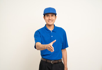 Happy delivery asian man in blue uniform standing on isolated white background. Smiling male service worker. Delivery courier and shipping service.