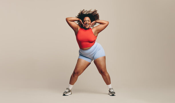 Fun and body movement: Fit woman enjoying a dance workout in a studio