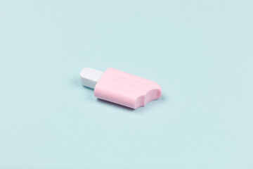 closeup of a pink popsicle on cyan surface icecream