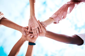Hands stacked, motivation and team building on a blue sky for trust, community and about us....