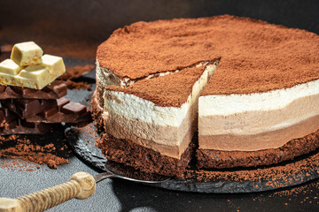 three chocolates cake. mousse cake on a dark background. Food recipe background. Close up