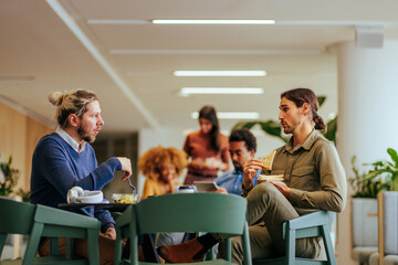 Coworkers discussing business at lunch.