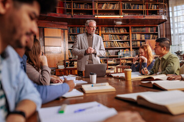 Professor giving lecture in library.