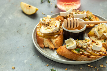 toasts croutons with cheese camembert and pear, honey, walnut, banner, menu, recipe place for text, top view
