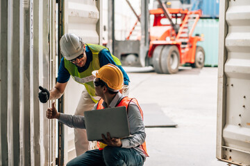 Team Engineer and worker wear safety uniform check control loading freight cargo container use computer laptop at commercial dock warehouse,transportation import,export logistic industrial service