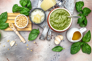 bowl with green pesto pine nuts, parmesan and garlic. Food recipe background. Close up