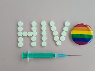 Inscription hiv next to syringe lgbt sign and condom