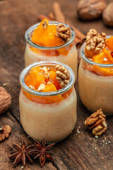 Creamy dessert with pumpkin mousse on a wooden background. place for text.