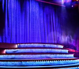 Elegant theater stage with closed blue curtain