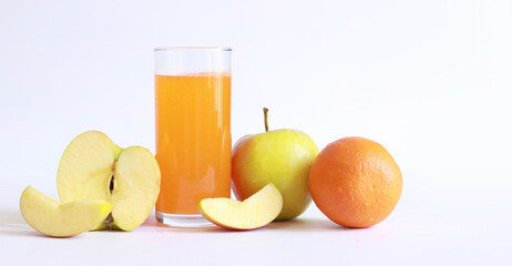 Tall glass with soluble multivitamins and fruits on a light background, empty space for text. Healthy food concept.
