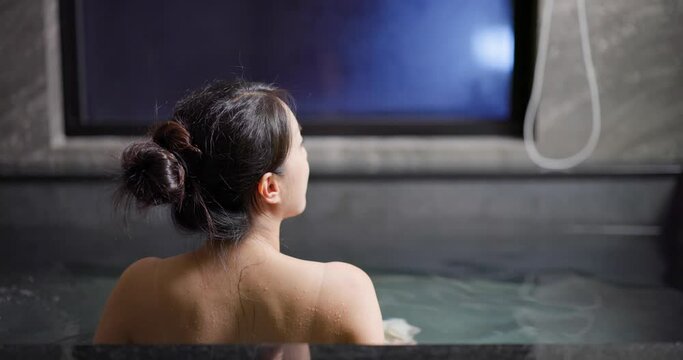 Asian woman enjoy onsen bathtub