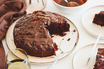 Delicious chocolate cake brownie with cherries on white wooden table