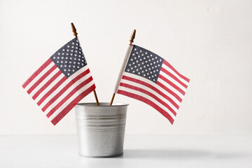 American flags in metal decorative bucket on white background. Concept , backdrop with copy space for USA Independence Day. © svetlana_cherruty