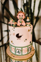 Delicious reception. Festive children's baptism cake. Birthday cake on a background party decor. Copy space. Celebration concept. Trendy Cake. Candy bar.