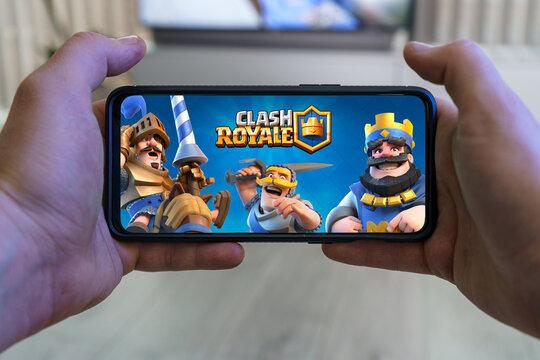 Playing Clash Royale mobile game. Point of view gaming Clash Royale game on smartphone