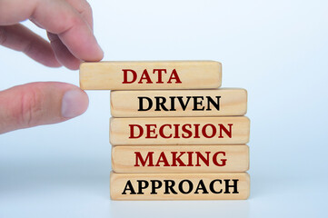 Hand holding wooden block with text Data Driven Decision Making Approach text on wooden blocks. Business culture and Operational excellence concept