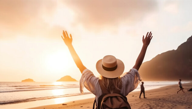 Happy women wearing hat and backpack raising arms up, beach sunset. Celebration, life, vacations.