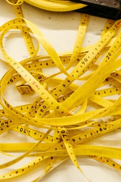 A vertical shot of a yellow measuring tape