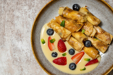 Pancakes with berries and condensed milk