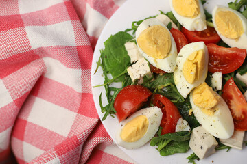healthy hearty diet salad of products with a low glycemic index of arugula greens and spinach eggs and tomatoes with cheese pieces
