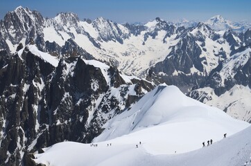 group of mountaineers climbing up on snow slopes, Mont Blanc massive, French Alps - 594285875