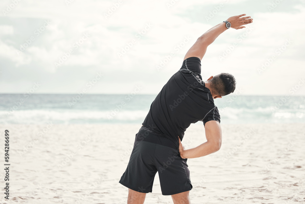 Canvas Prints Ill reach my fitness goals sooner than later. a young man stretching on the beach.