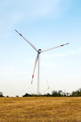 Wind energy. Wind power. Sustainable, renewable energy. Wind turbines generate electricity. Windmill farm on mountain with sunset sky. Green technology. Renewable resource. Sustainable development.
