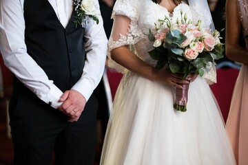 Beautiful bride with a bouquet and a groom