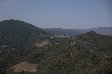 Scenic landscape of a rural village surrounded by rolling hills seen from an elevated viewpoint