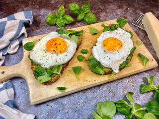 Pesto sandwiches with egg, lettuce and parmesan cheese from the side