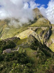 Fototapeta na wymiar Landscape of the stunning mountains of Machu Picchu covered in the fog in Peru