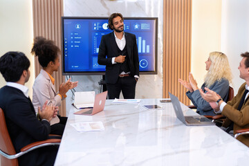 Employee on job corporate Business colleagues around the table look presentation from large screen