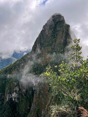 Landscape of the stunning mountains of Machu Picchu covered in the fog in Peru