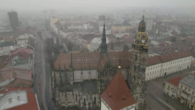 Drone footage cityscape of St. Elisabeth's Cathedral in Kosice, Slovakia with snow falling