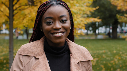 Female portrait close-up young serious pensive beautiful stylish african american woman standing outdoors looking at camera frustrated upset ethnic girl thinking posing with sad expression on street