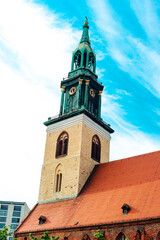 Fototapeta na wymiar BERLIN, GERMANY - MAY 27, 2017: St Mary's Church tower on blue sky background