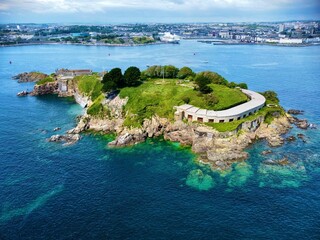 Fototapeta premium View of Drake's Island in Plymouth UK, blue sky with white clouds