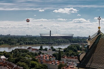 Stadion Narodowy and a balloon at the shore of the Vistula river in Warsaw, Poland.