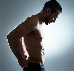 Every man thinks his burden is the heaviest.... Studio shot of a young man washing his hair in a...