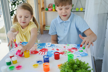 Fototapeta premium Children paint fingers drawing baby painting hand therapy children art play. Sensory development and experiences, themed activities with children, fine motor skills development.