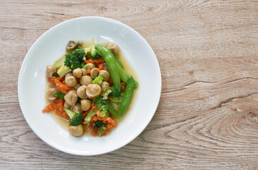 stir fried slice broccoli with green pea and straw mushroom vegetarian food on plate 