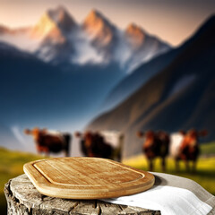 Desk of free space for your milk product. Blurred background of cows and Alps mountains landscape. 