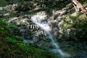 Naklejka na ściany i meble Beautiful landscape of a waterfall in a forest